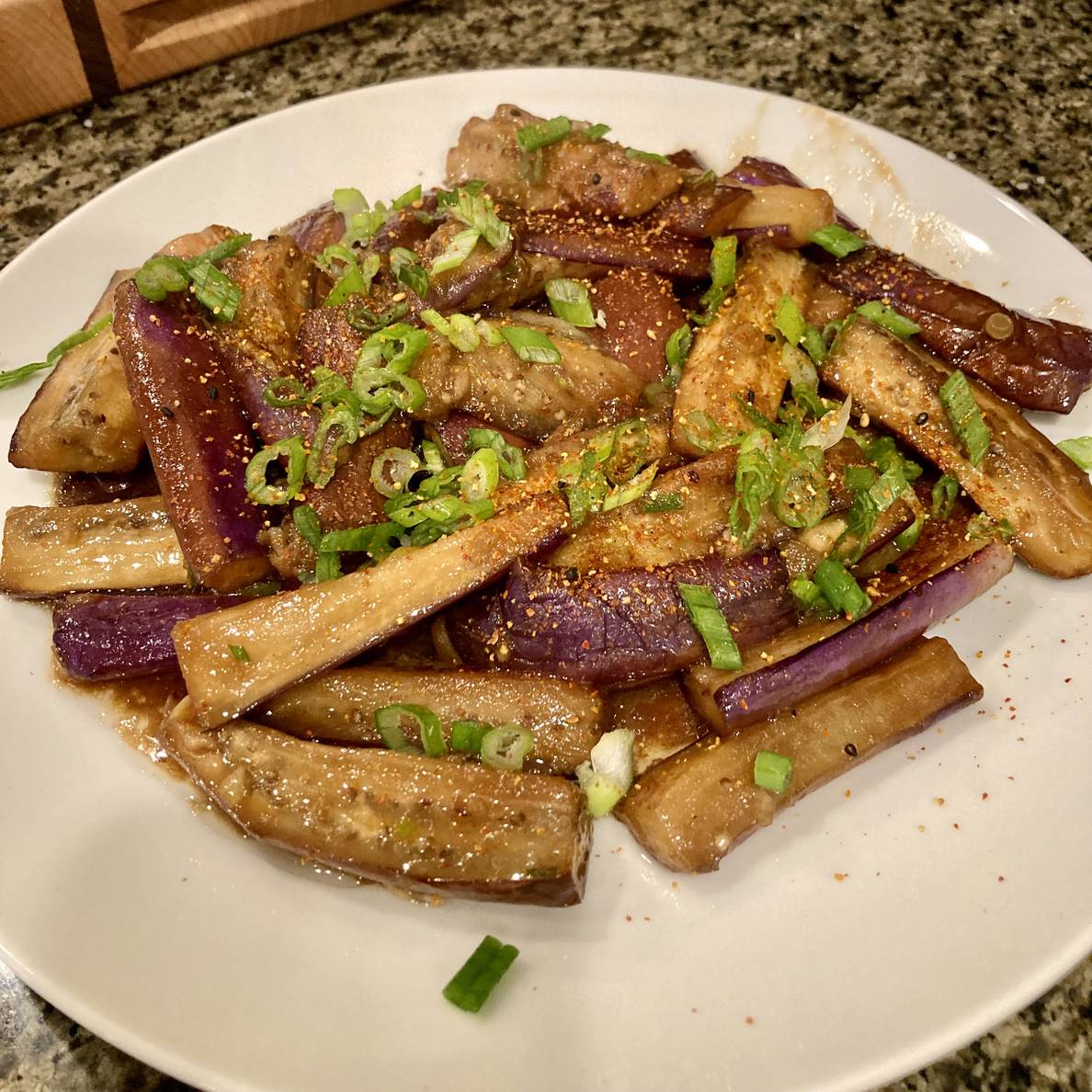 A plate of Chinese eggplant with some sauce.