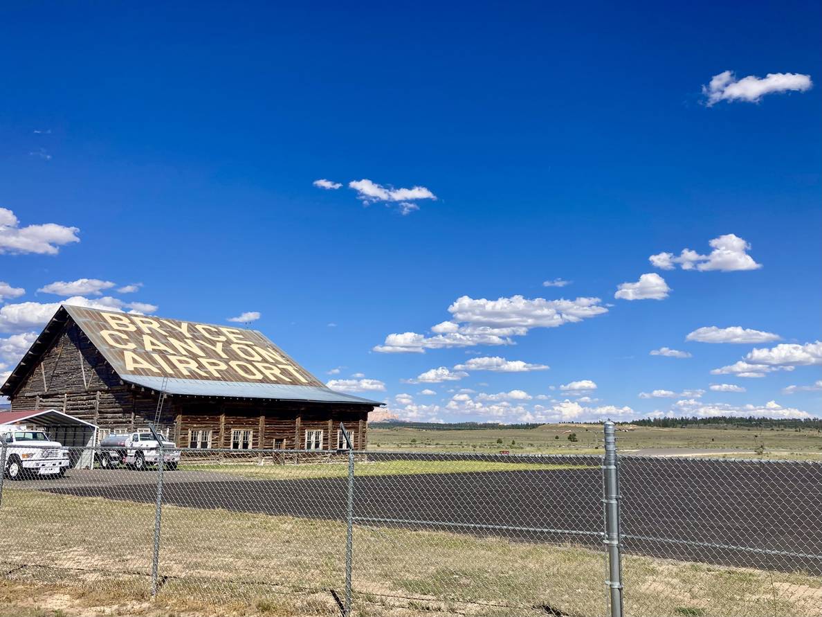 A barn with large letters on the roof saying “BRYCE CANYON AIRPORT.”