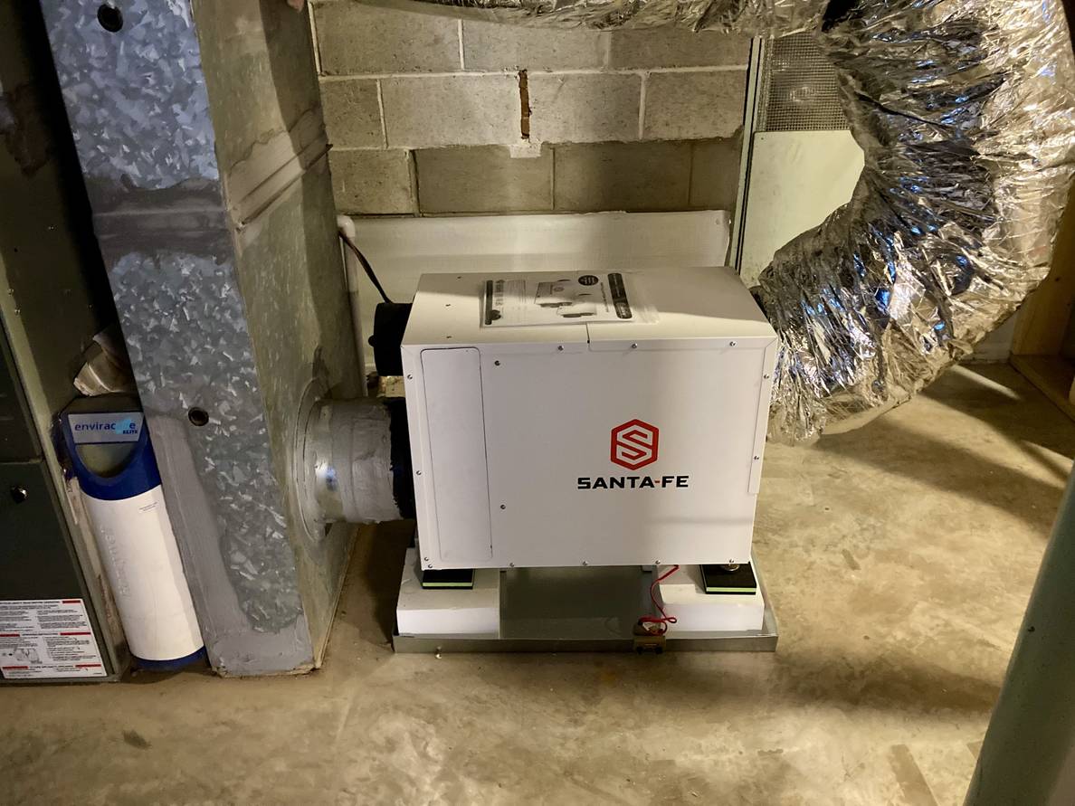 A metal box with the words “Santa-Fe” connected to the return of an HVAC system.