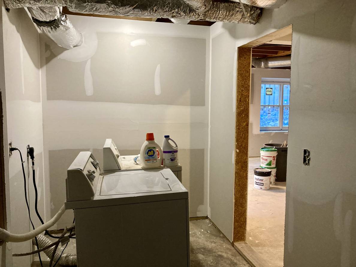 A photo of the same partially finished laundry room from another angle