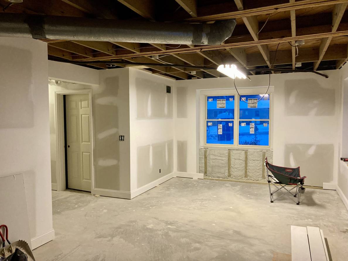 Another photo of the same basement from a different angle. The newly installed laundry room door is visible from this angle.