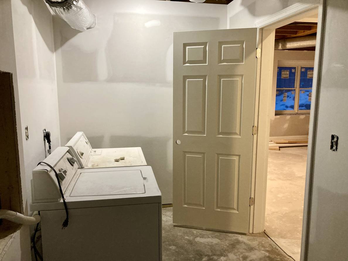 Another photo of the laundry room. From this angle the newly installed door is visible.