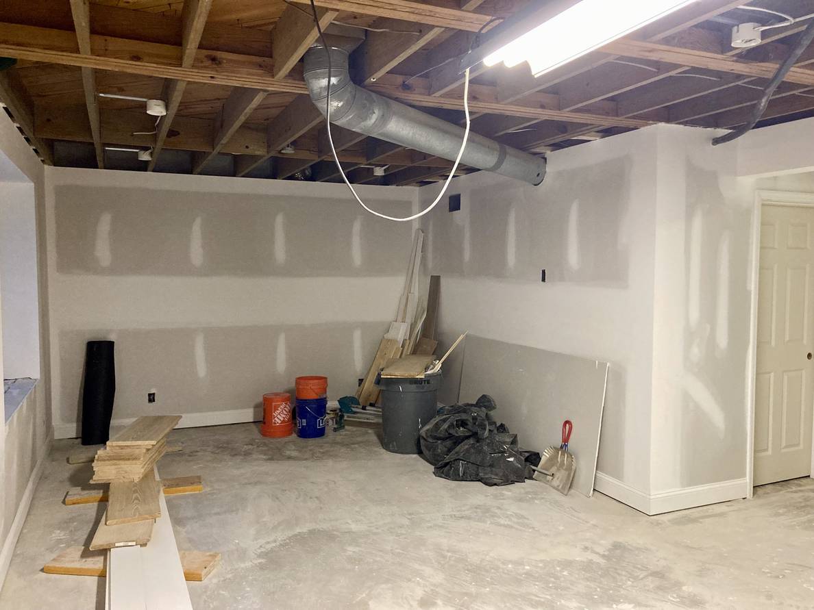 A photo of the same basement from a different angle. Partially visible is the newly installed door to the utility room.