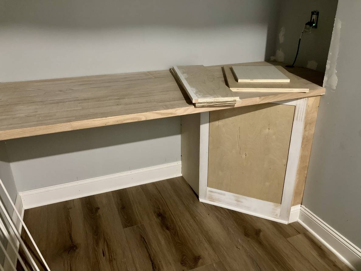 A photo of a partially finished counter with a wooden cabinet under one end.