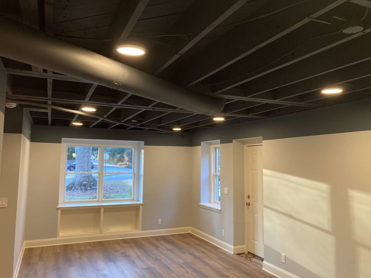 Another photo of the same basement. This one has circular led lights installed in the ceiling.