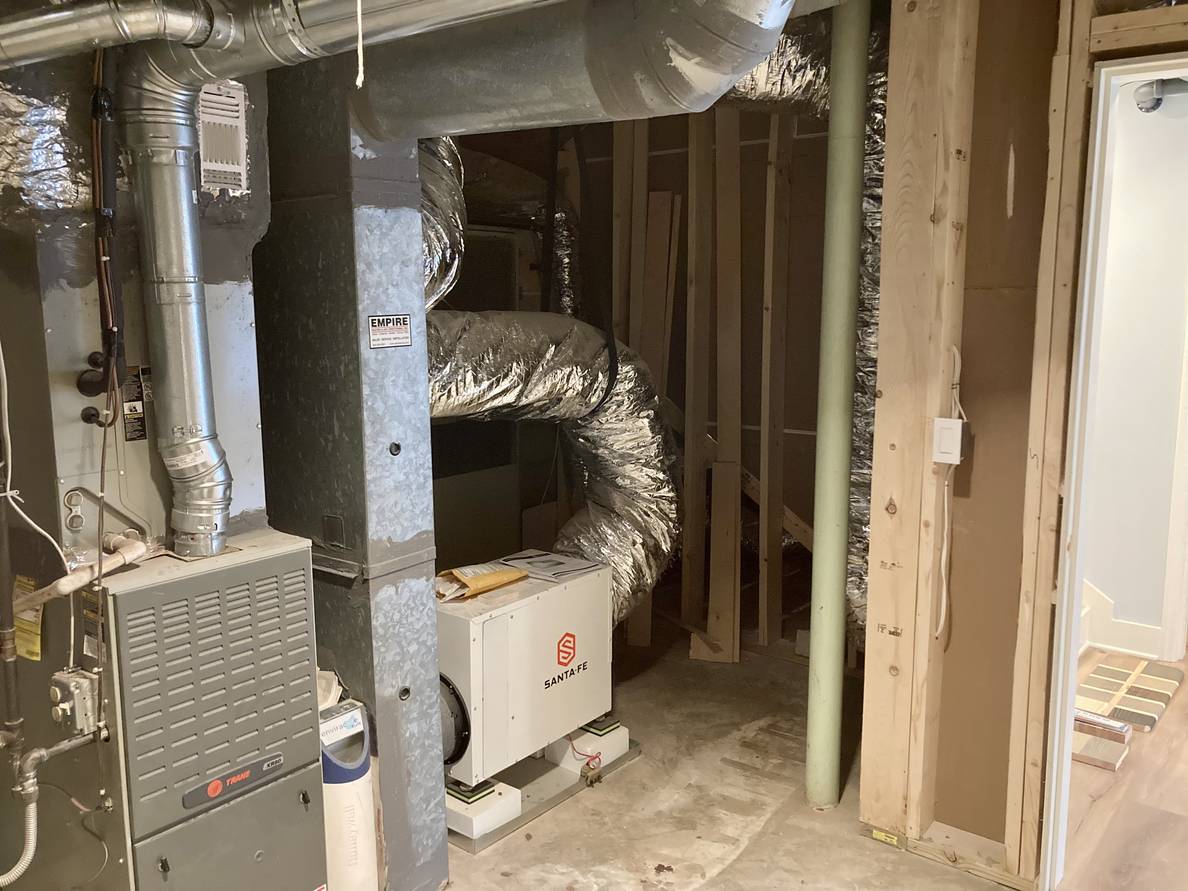 Another photo of the utility room. From this angle the HVAC with the new dehumidifier can be seen.