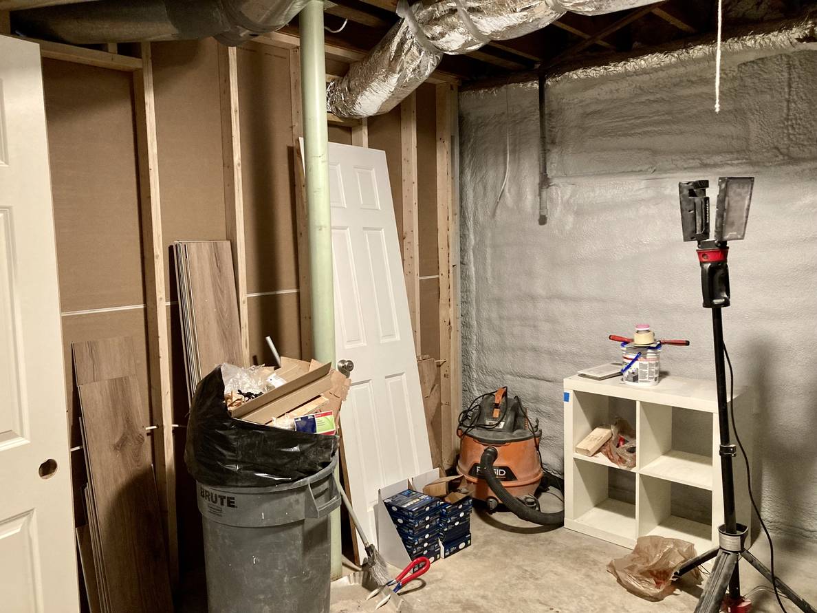 A photo of the utility room. It remains unfinished. The back of the main space wall meets the exterior wall which has been spray-foam insulated.