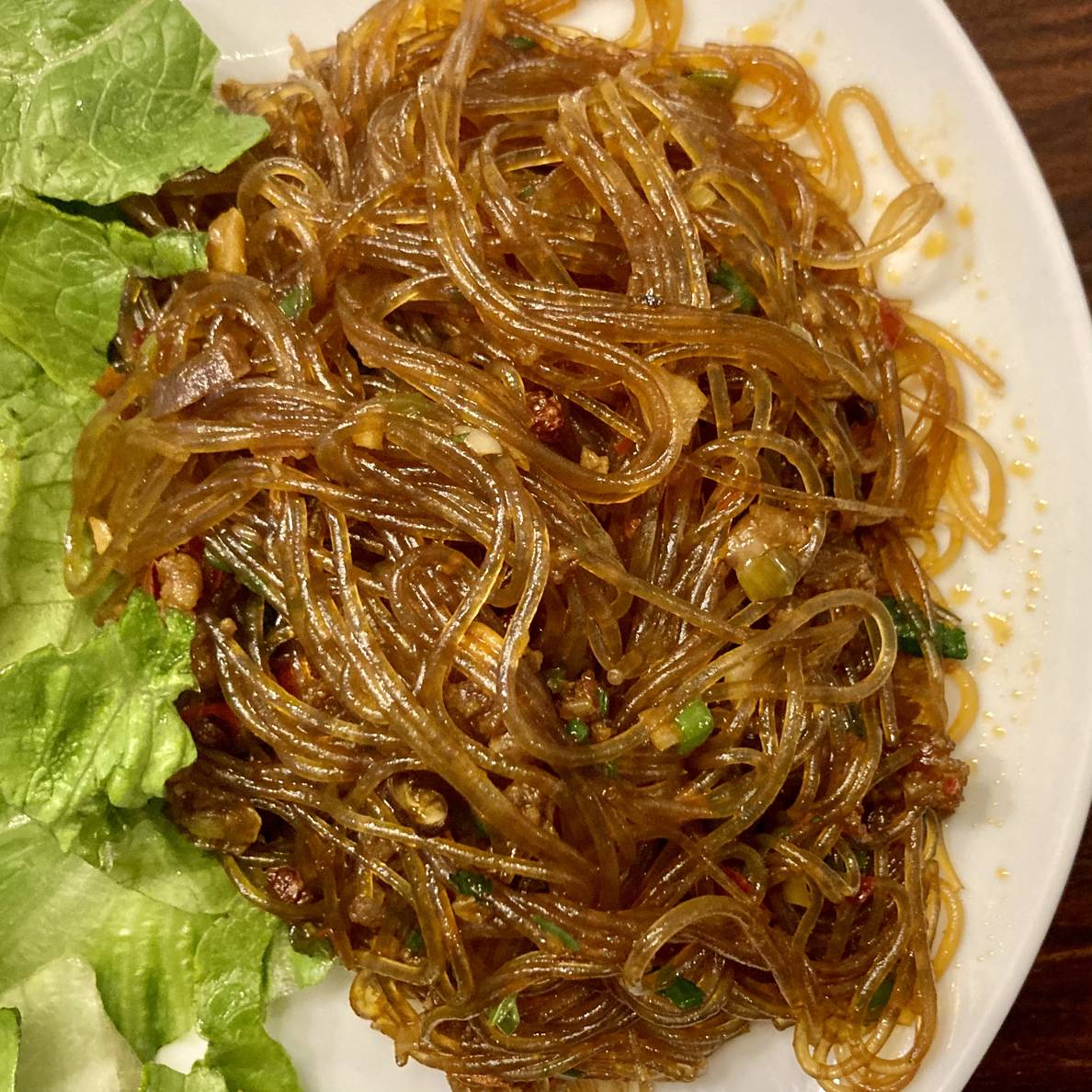 A photo of a plate with Ants Climbing Trees noodles on it.