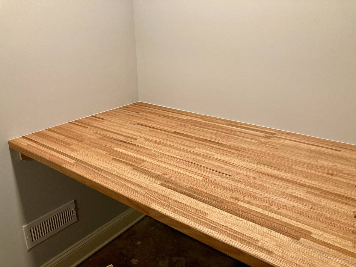 A photo of a butcher-block counter-height shelf. The wood has a richness from the finishing coat.