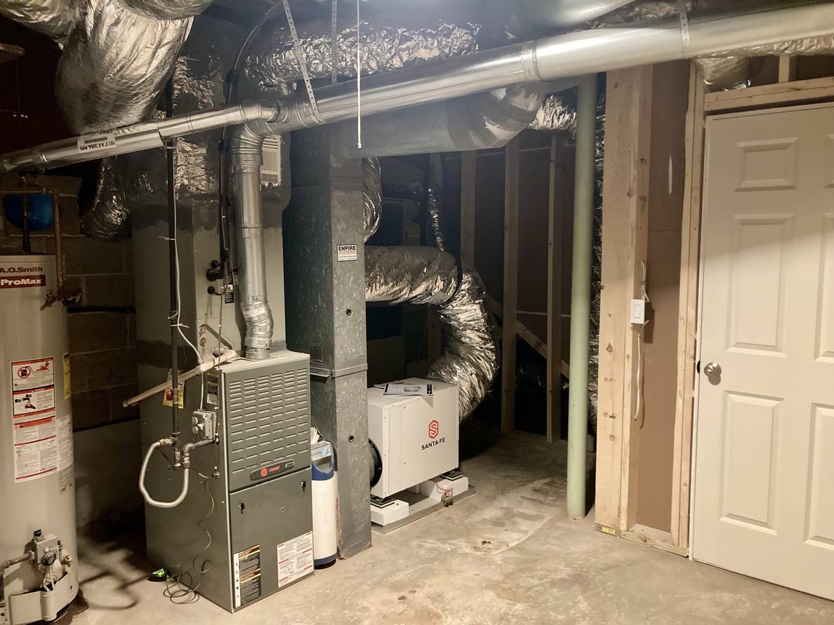 Another photo of the utility room from a second angle. From here the new whole-house dehumidifier is visible, connected to the HVAC return.