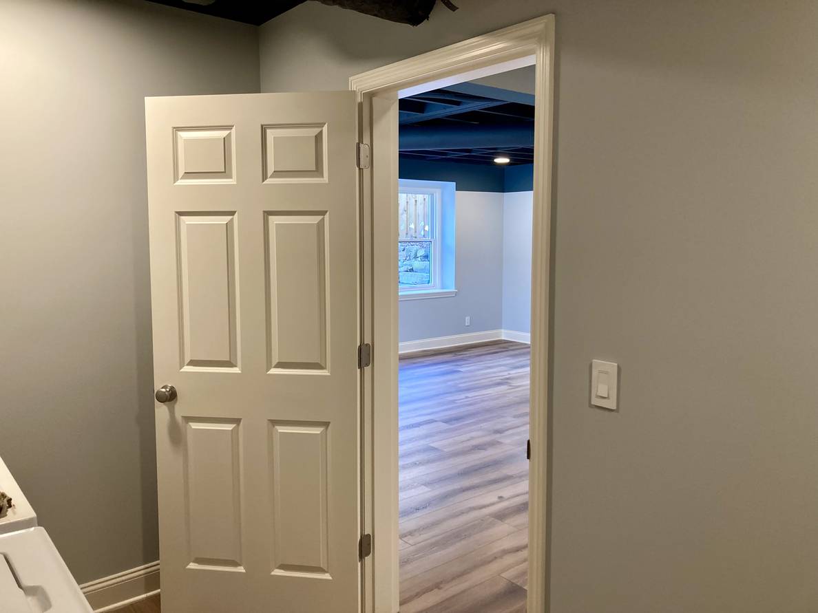 The after photo from this corner. This position is now in the laundry room. The angle looks through the laundry door and glimpses the same window as before.