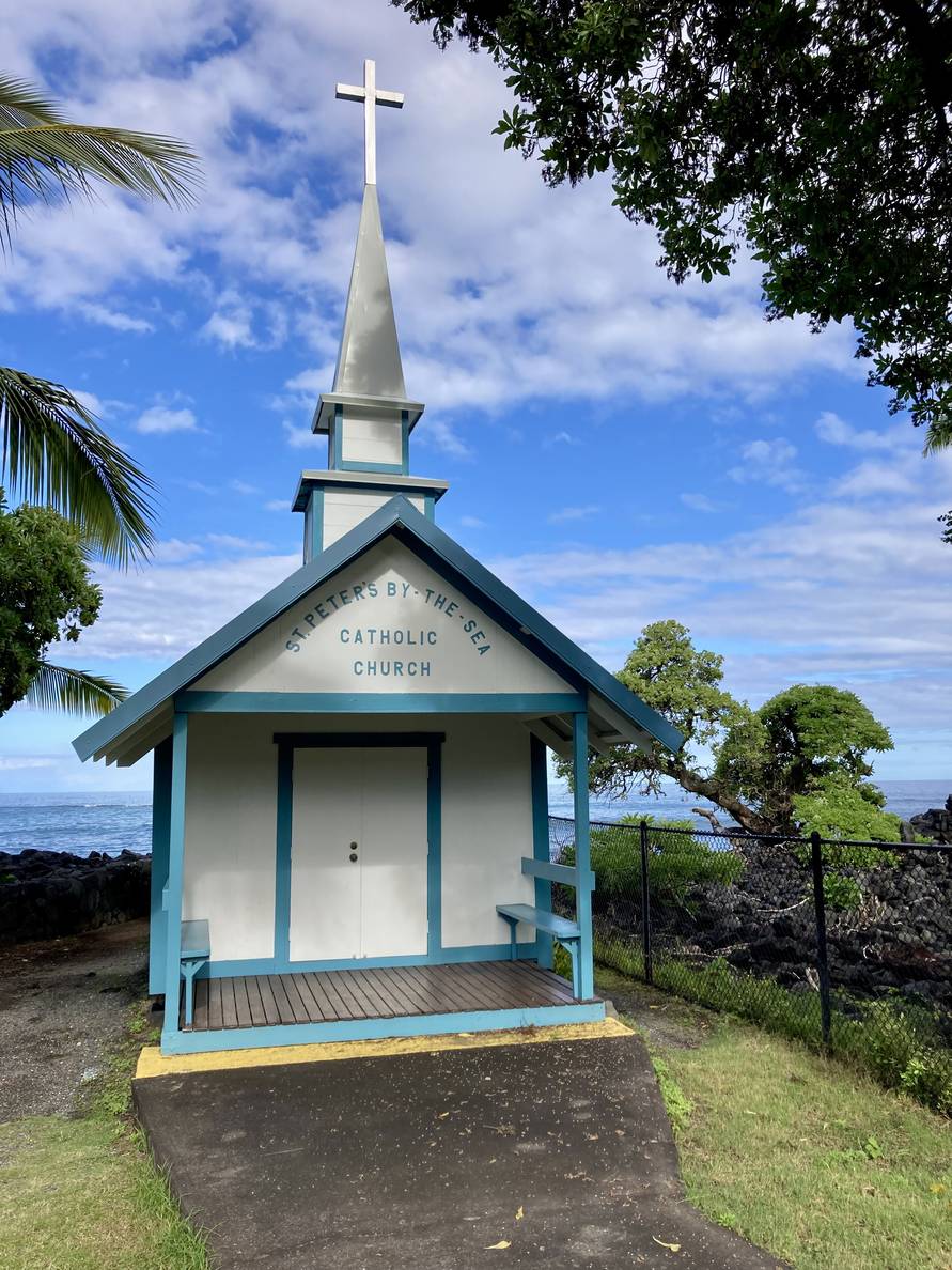 A photo of a tiny chapel right on the coast.