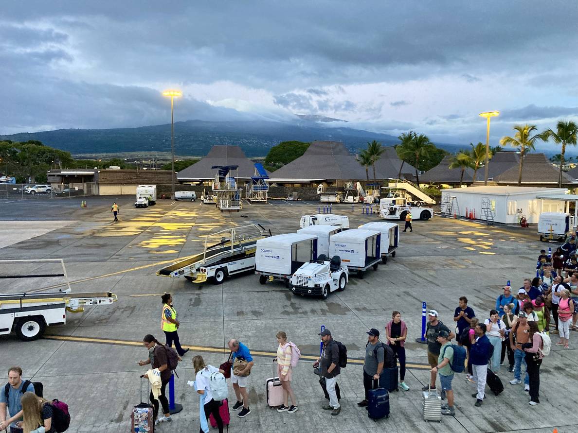 A photo from the stairs boarding the plane at Kona airport looking back at the island.