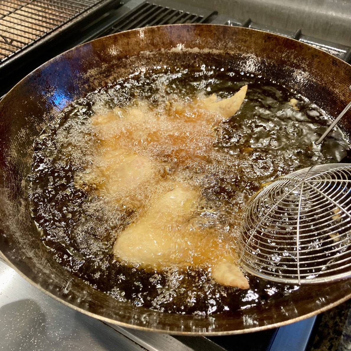A photo of the chicken frying in a wok.