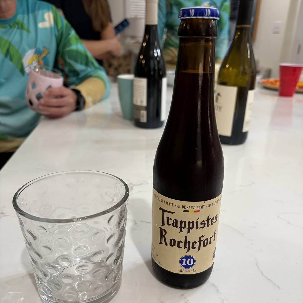 A photo of a 330ml bottle of Rochefort 10 on a kitchen counter.