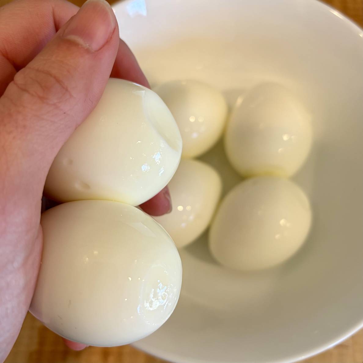 A photof me holding two of the steam-boiled eggs, showing their bottoms.