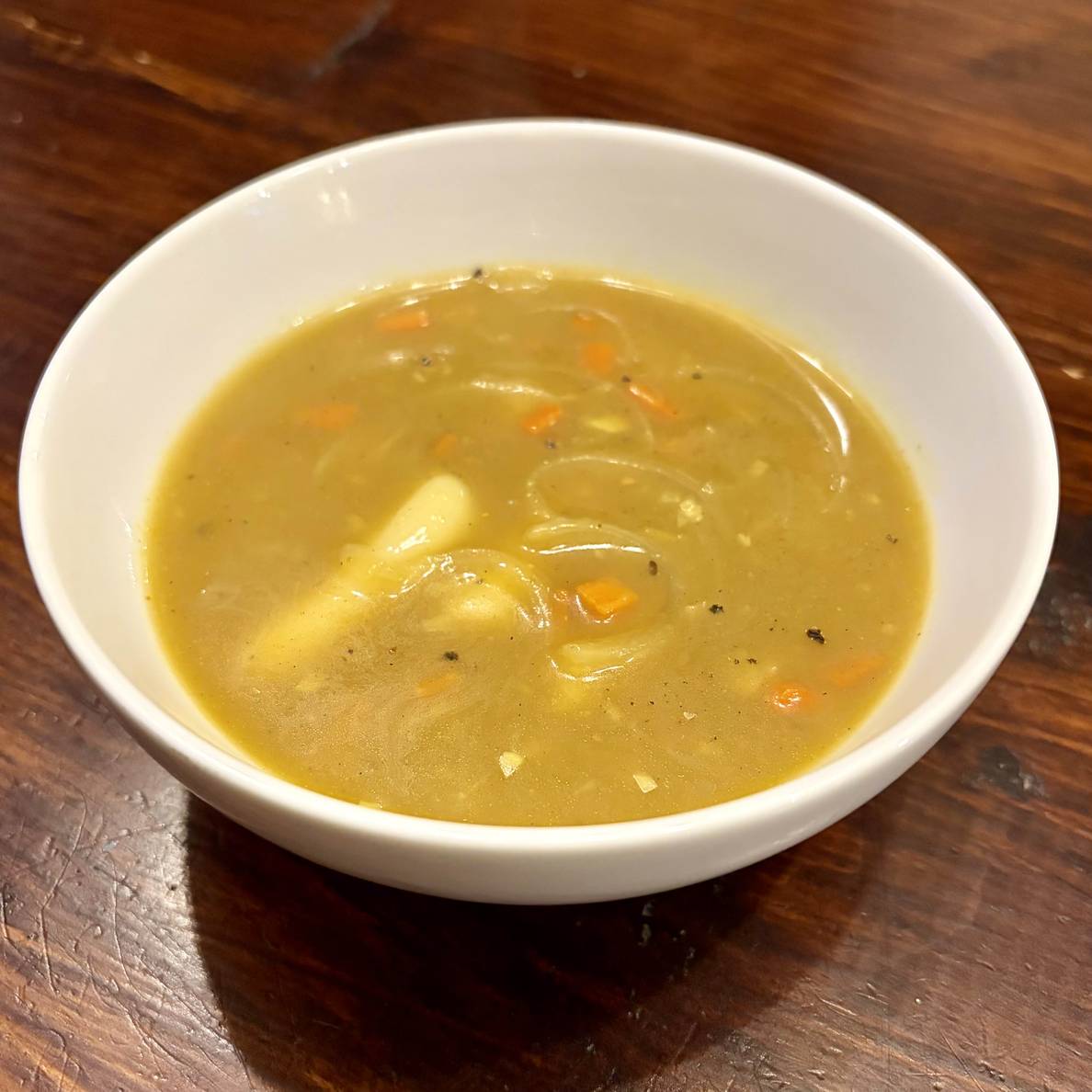 A photo of the finished stew in a bowl. Compared to the simmering picture, the broth has thickened up.