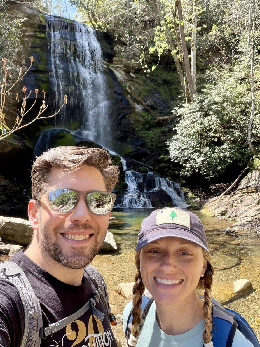 A photo of Megan and me in front of a waterfall with a plunge pool at its base