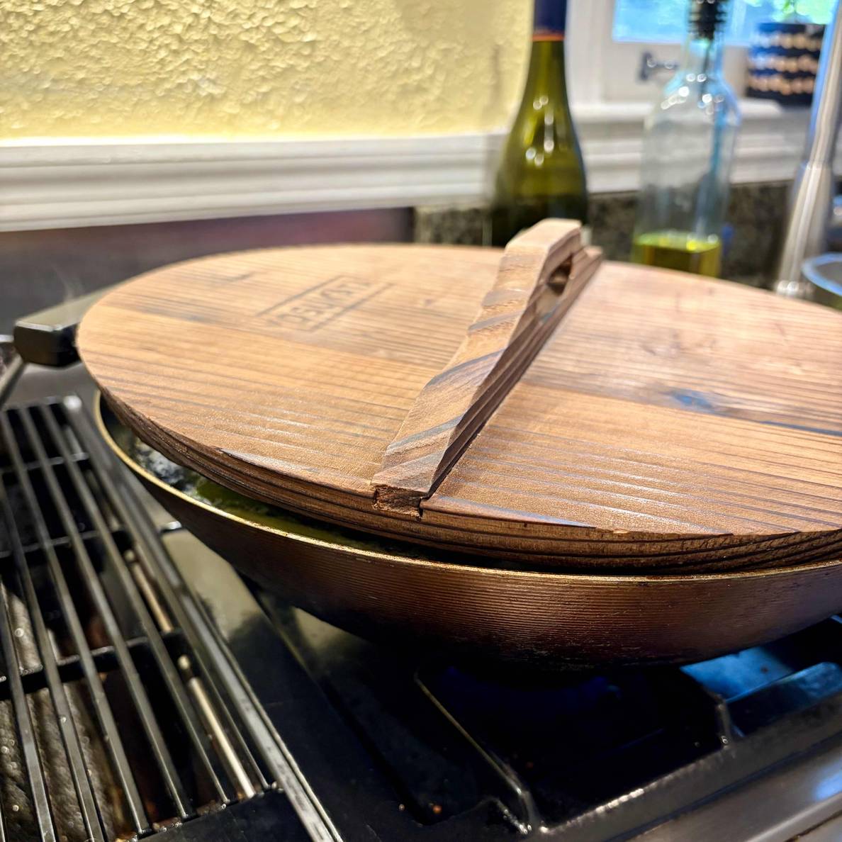 A photo of the covered wok with a the lid not quite making contact to the rim of the wok.